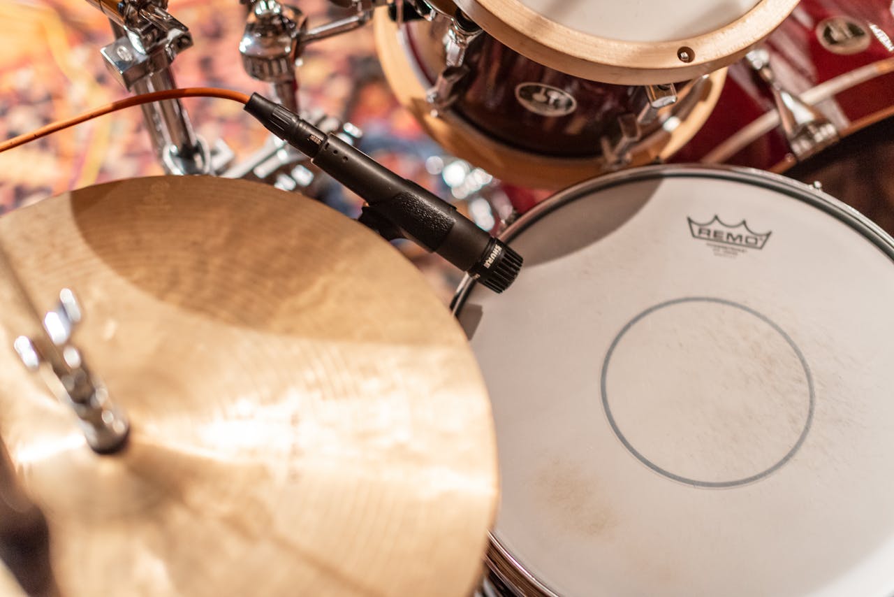 A detailed view of a drum set and microphone setup in a recording studio in Georgia, USA.